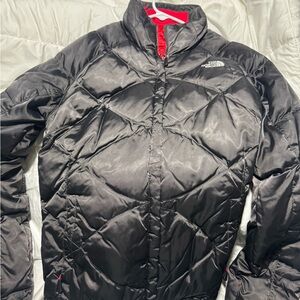 The North Face Women's Black Jacket with Red Details.